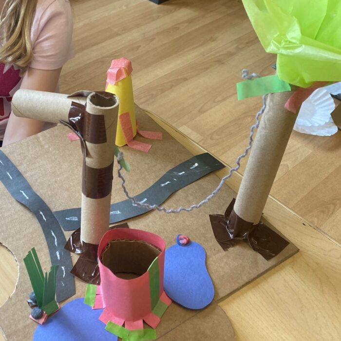 Playground community creation with trees, small lakes, roads, and an Octopus character